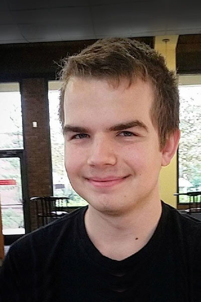 A young man smiling indoors