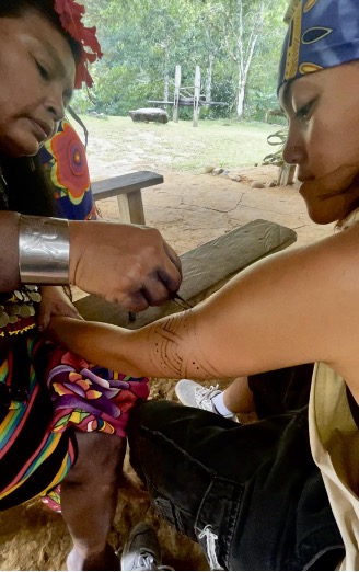 Thalia with a Panamanian add ink on their arm