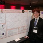 Aeon smiling and standing next to URCAD project